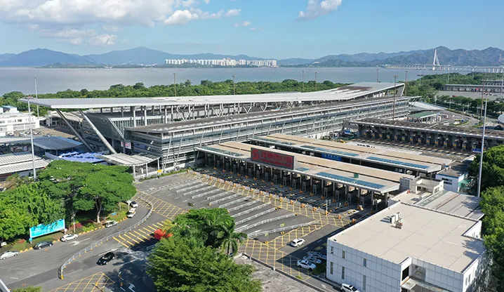 Cross-border coach bus traveling over Shenzhen Bay port bridge to Hong Kong