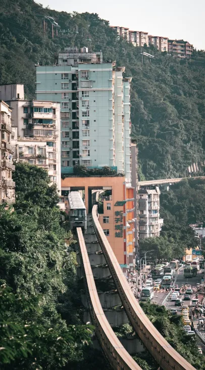 Chongqing Metro Line 2 monorail train passing through Liziba residential building
