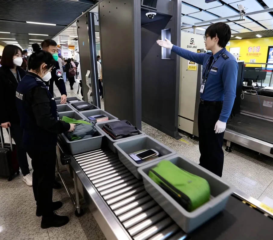 Passengers waiting in line for mandatory security check at China airport