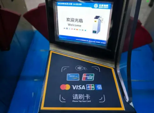 Foreigner using Visa Mastercard to tap and pay at Beijing Subway turnstile